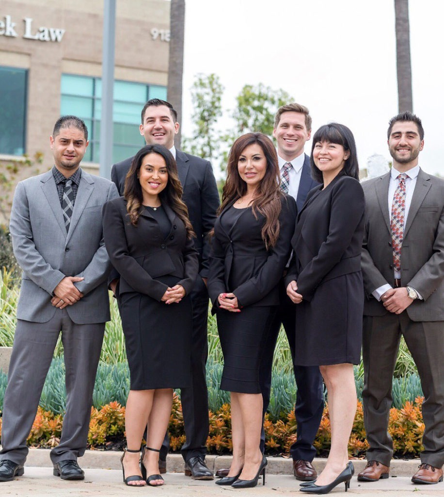 The Super Woman Super Lawyer personal injury law team outside the Avrek Law office on cloudy day