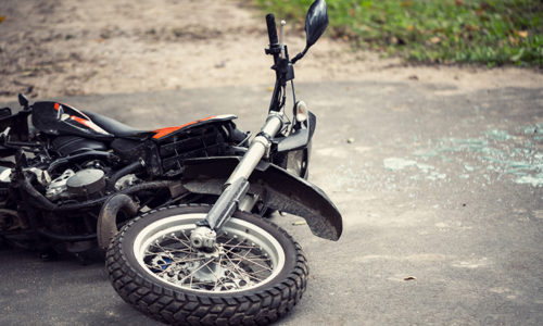 Motorcycle overturned on roadside, suggesting need for Irvine motorcycle accident attorney
