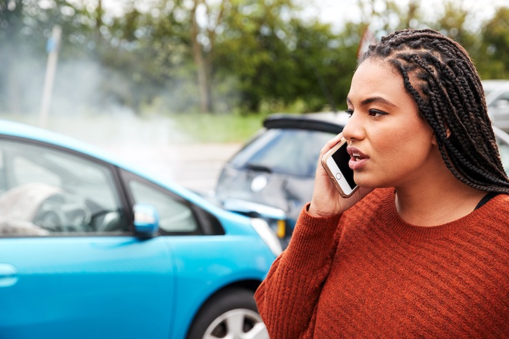 Woman on phone after crash, possibly in need of the best car accident lawyers in Phoenix