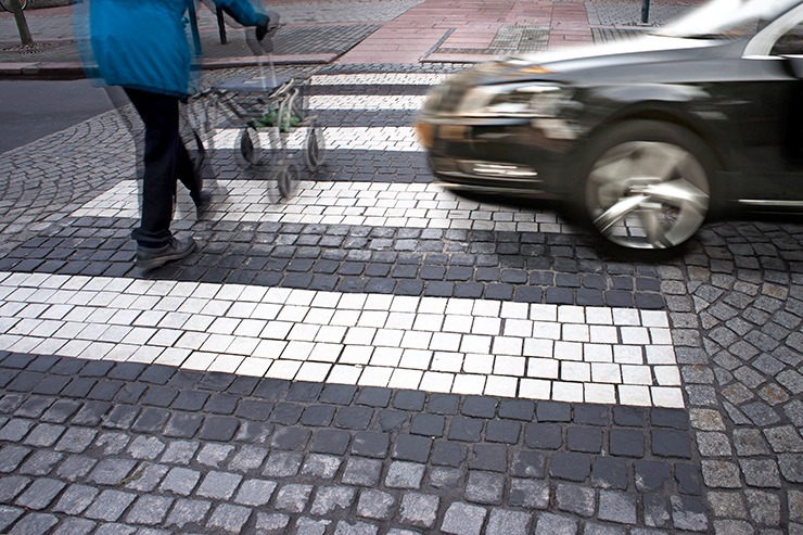 Car about to hit person in crosswalk, illustrating what are the main causes of pedestrian accidents