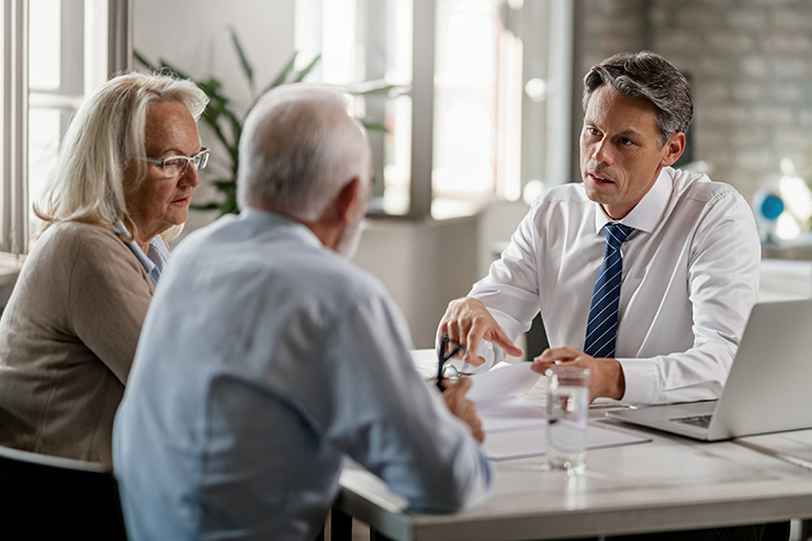 Lawyer speaking with elderly couple - find out what questions to ask a personal injury lawyer