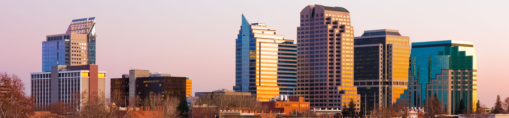 Sacramento cityscape at sunset, an area served by Sacramento car accident law firm Avrek Law