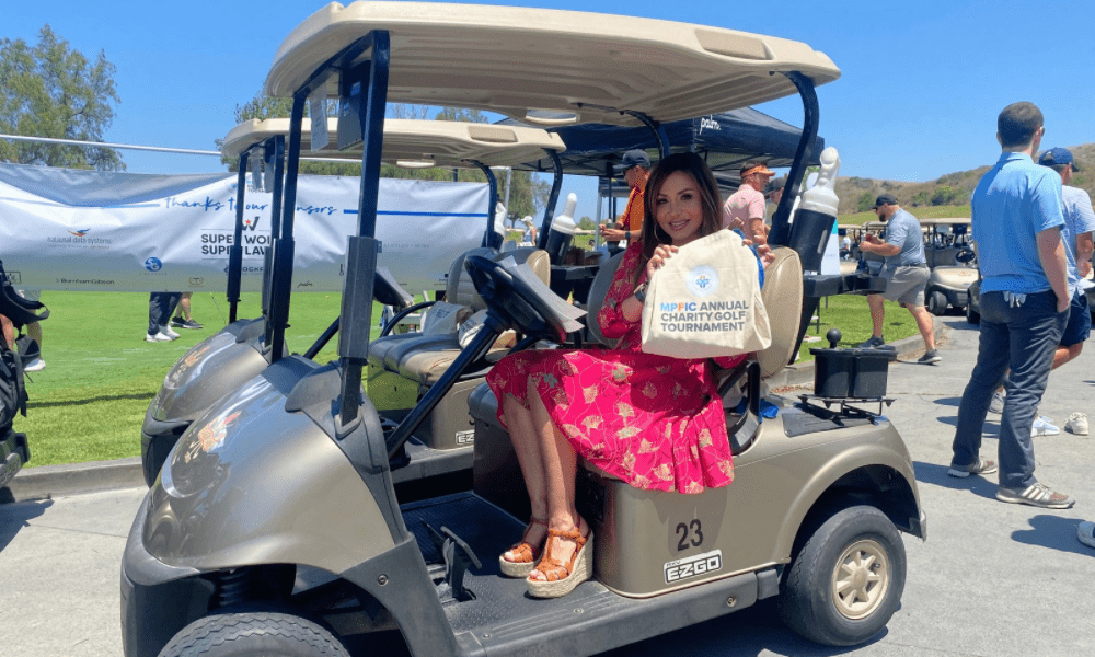 Maryam Parman on a golf cart at a charity event for MPFIC